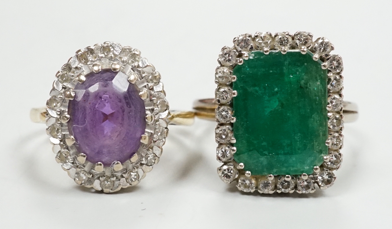 A modern 18ct gold, amethyst and diamond set oval cluster ring, size K/L and a white metal, emerald and diamond cluster set ring, gross weight 11.8 grams.